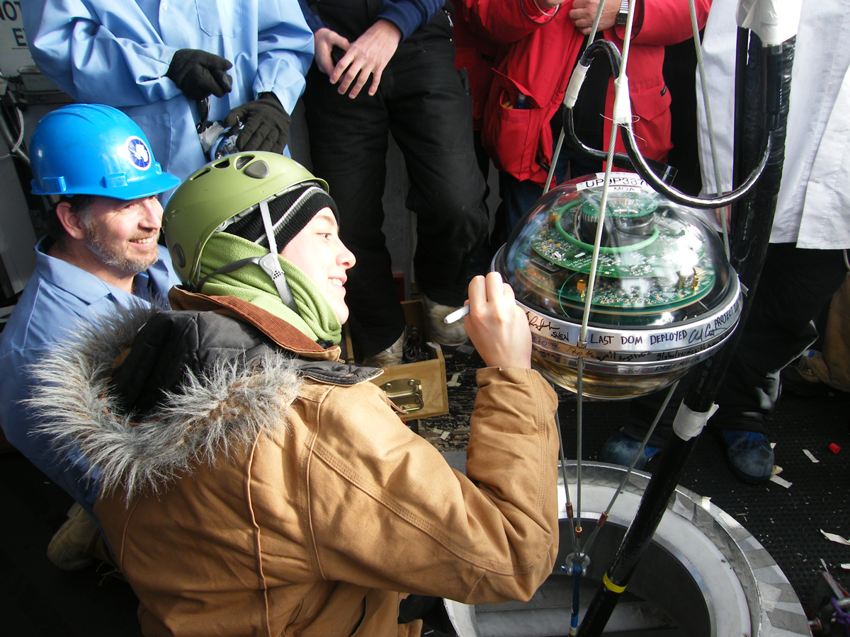 Construction completion was a major milestone for IceCube as well as the scientific community and reflects the efforts of hundreds of people. Here, winterover Freija Descamps signs the final Digital Optical Module before it’s deployed into the array. Credit: Gary Hill, IceCube/NSF